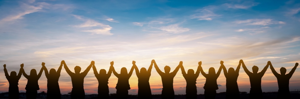 Silhouette of group hands over heads